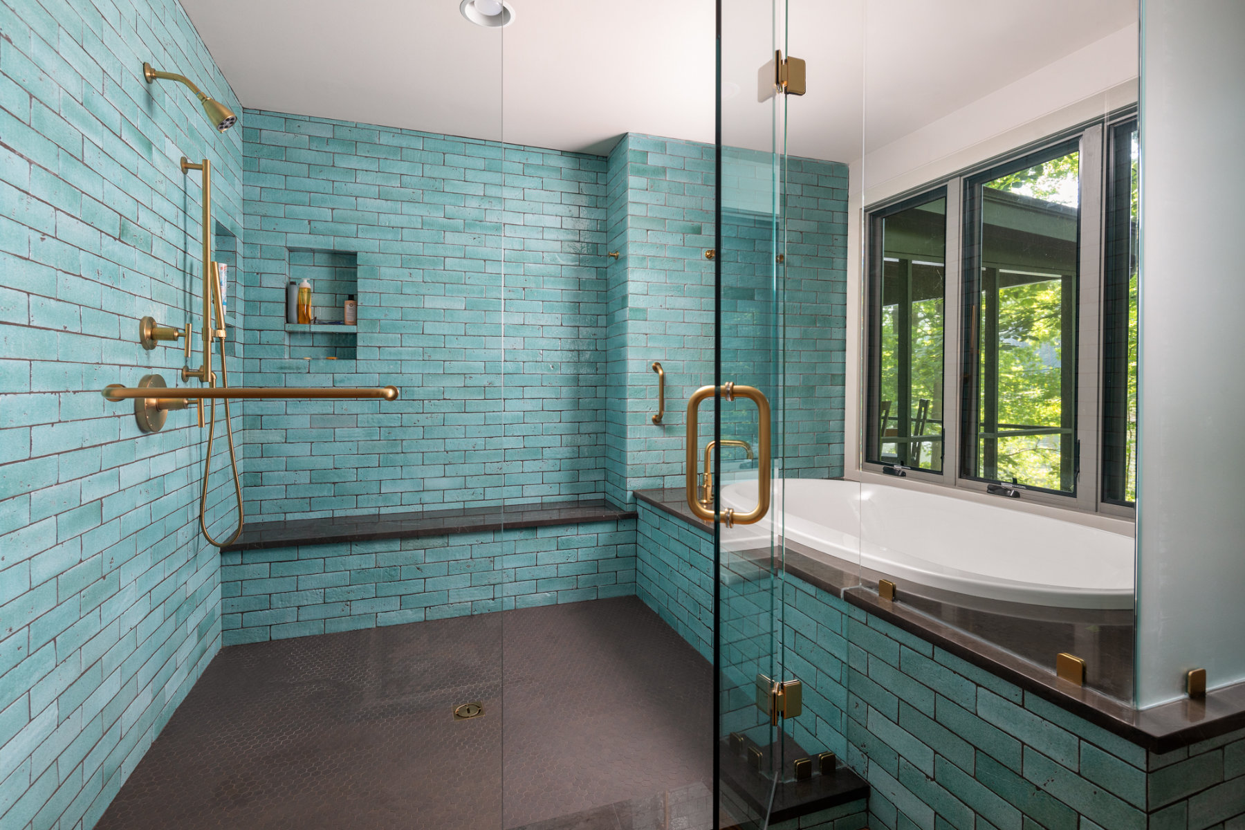 Bathroom displaying aqua tile in a shower and bath.